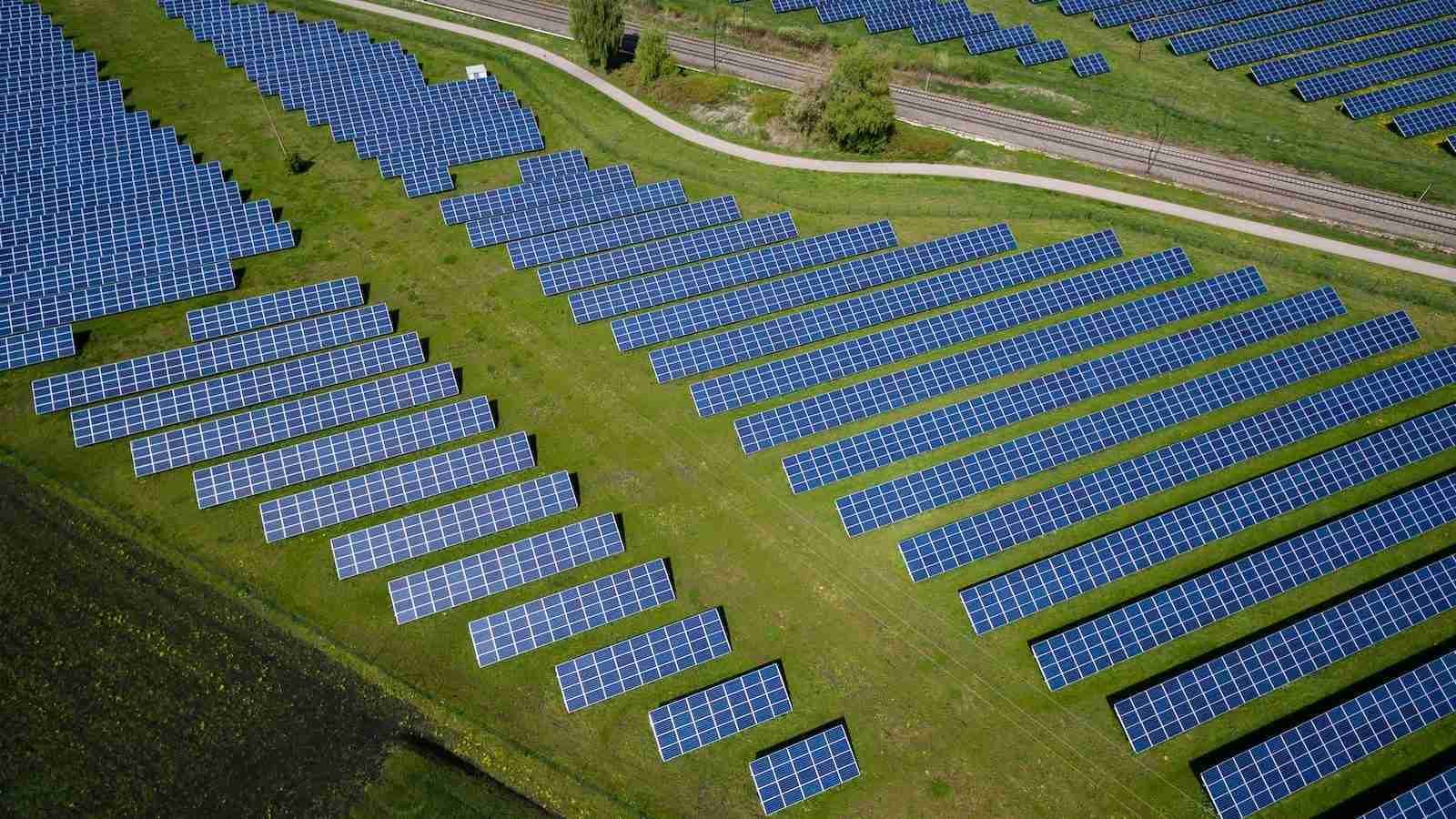 aerial photography of grass field with blue solar panels