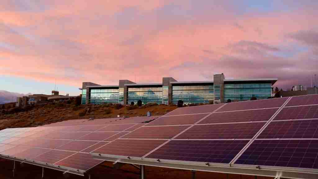 solar panels on brown field under white clouds during daytime