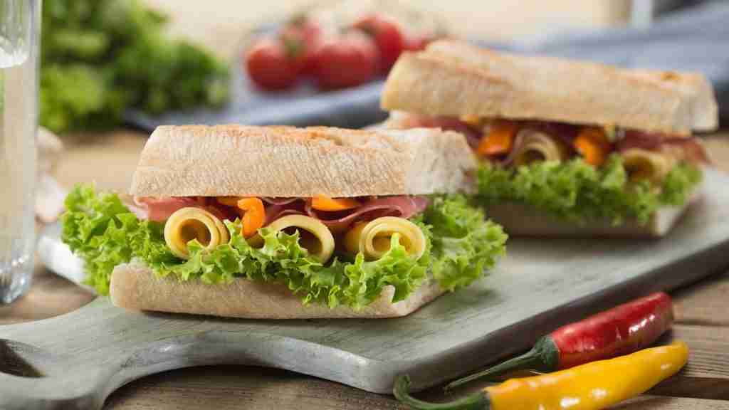 sandwich with lettuce and cheese served on chopping board