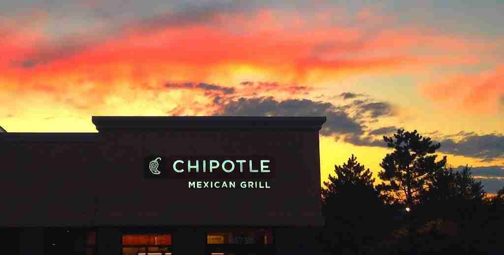 Chipotle Mexican Grill building in partial darkness, inviting exploration of interesting facts about Chipotle.