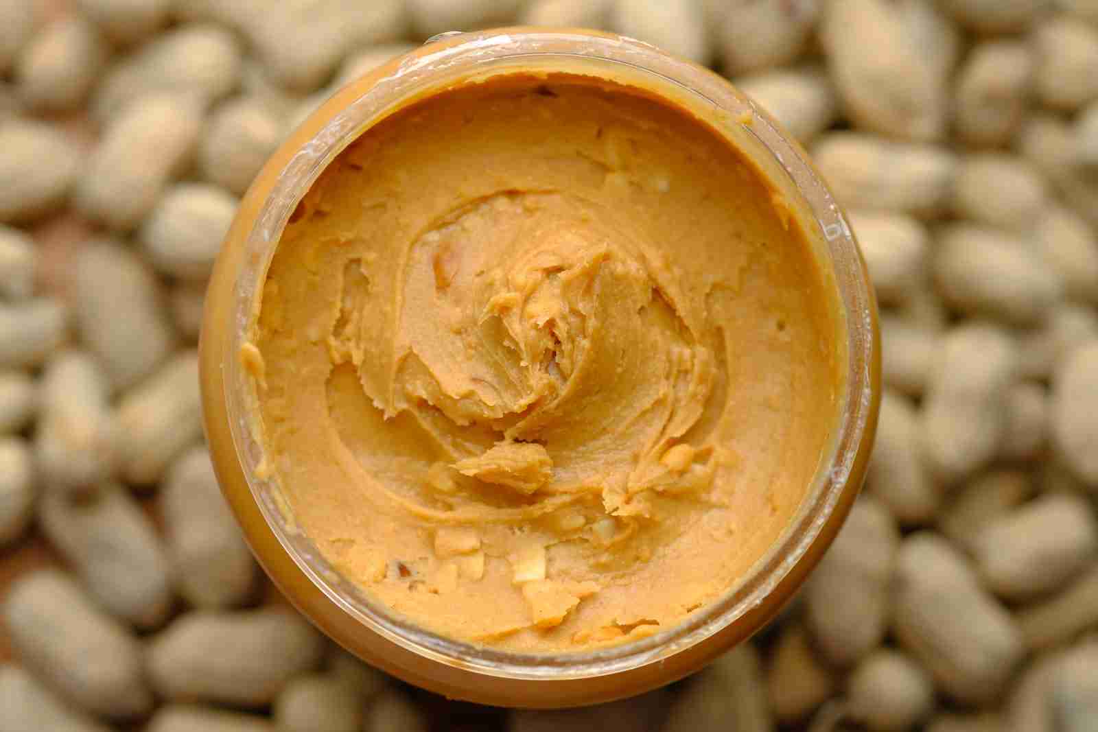 Peanut butter in brown round container