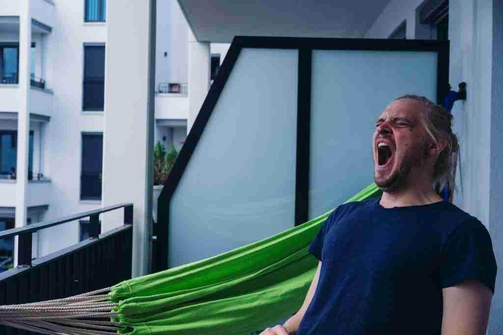 man in blue Yawning .