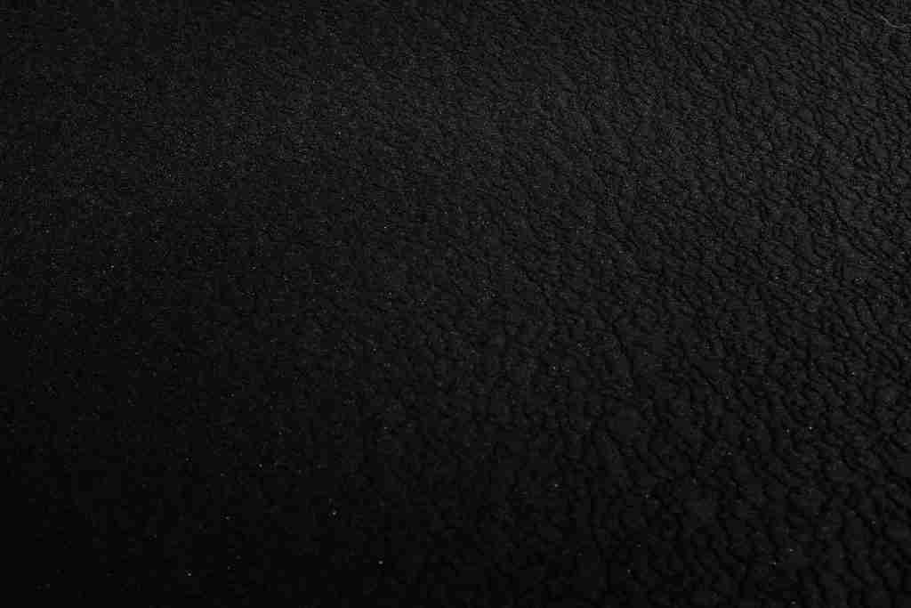 a black and white photo of a black surface