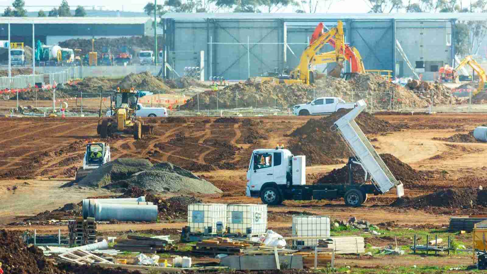 a construction site with trucks and construction equipment