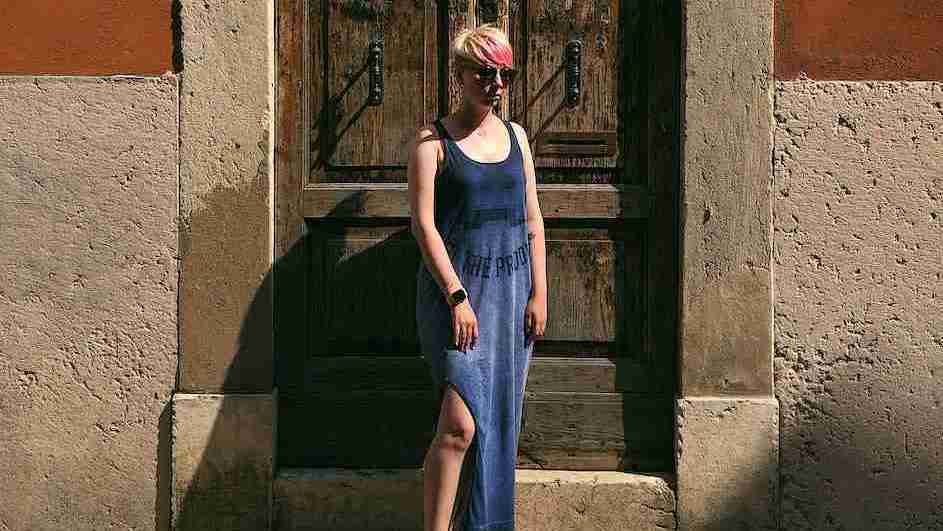 woman standing near door wearing a dress linked with dopamine fashion