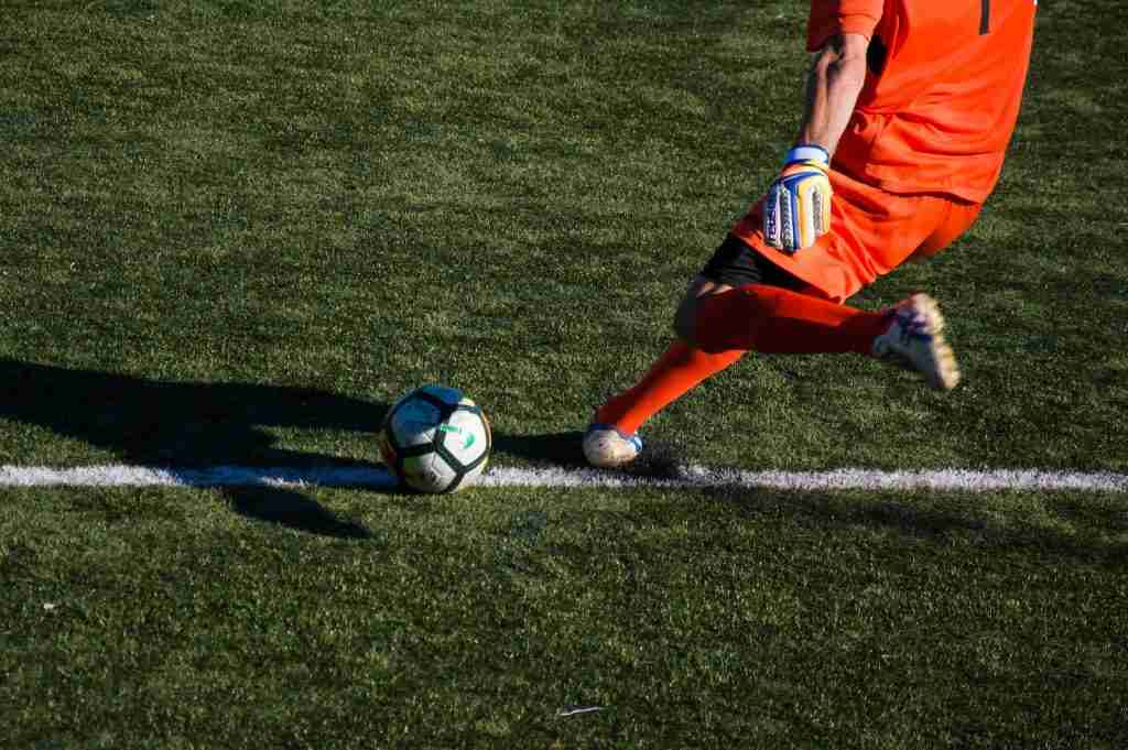 Player kicking football