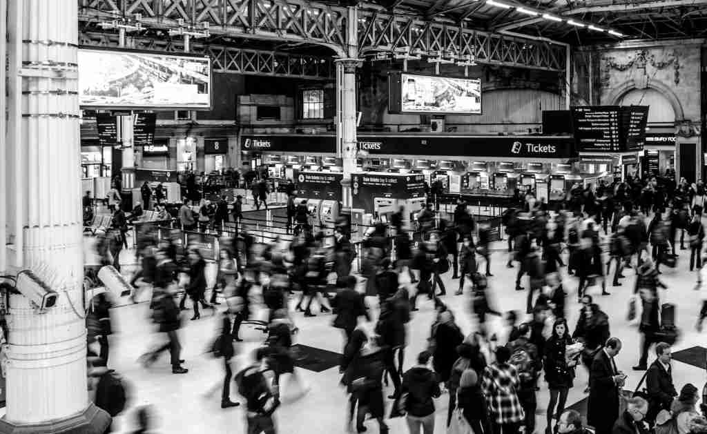 Grayscale Photography of People Walking in Train Station