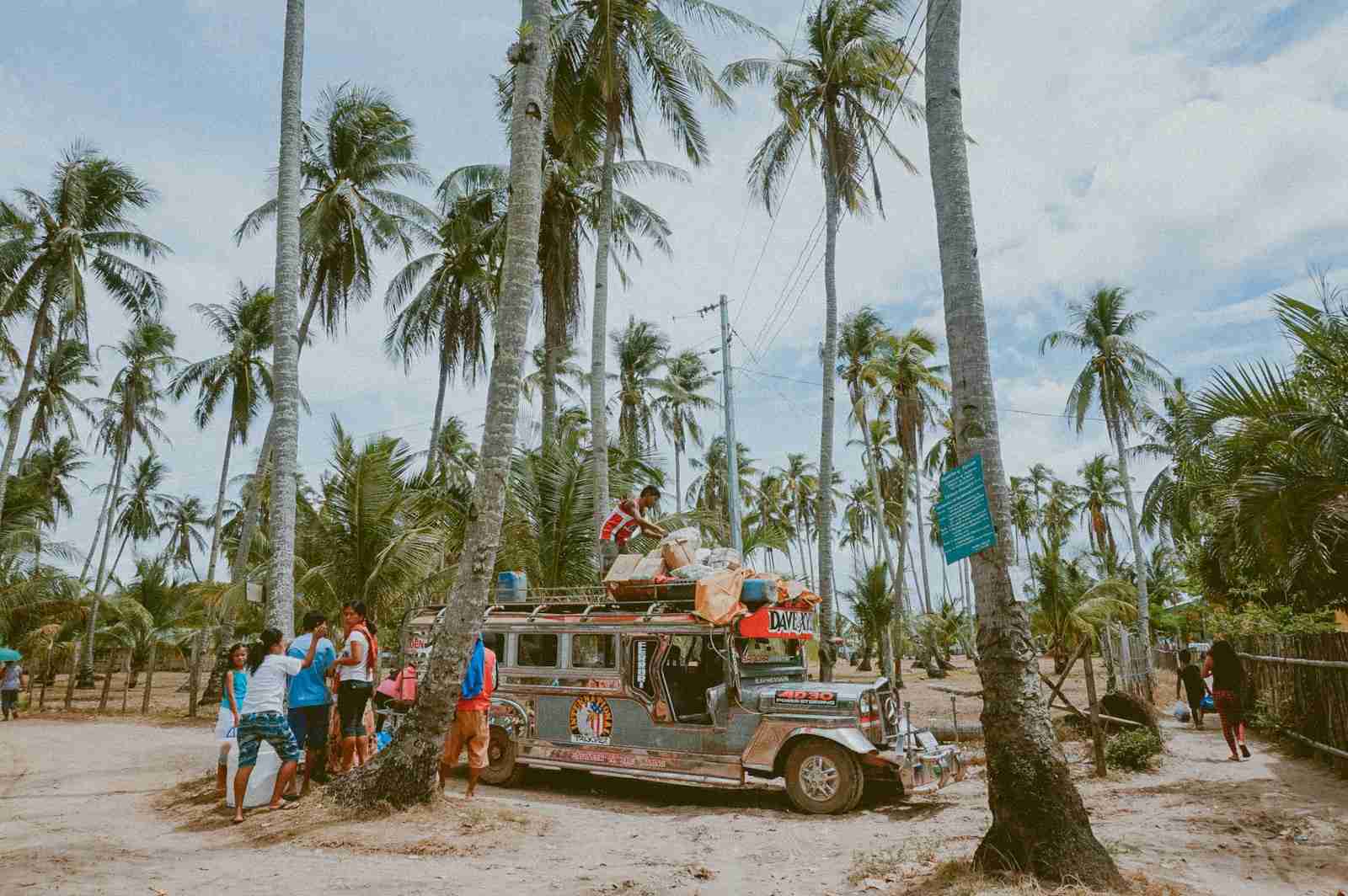 man on top of jeepny