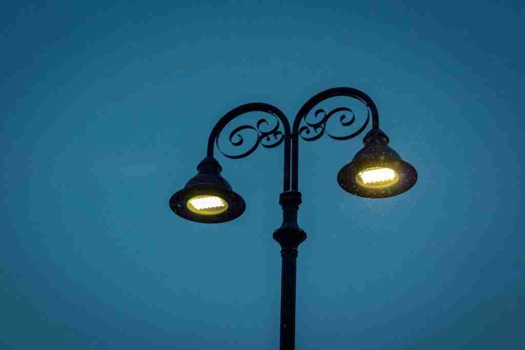 black 2-light street lamp turned on during night