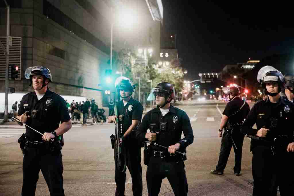 man in black shirt and pants holding black dslr camera