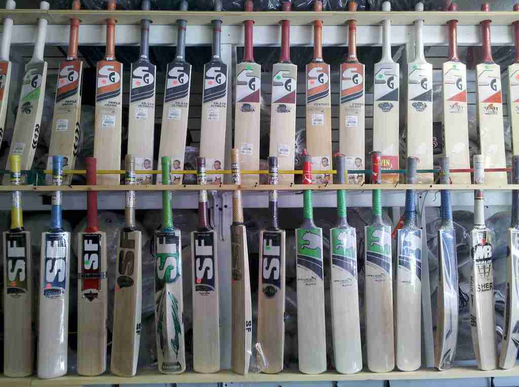 set of Cricket bats on a shelf. 