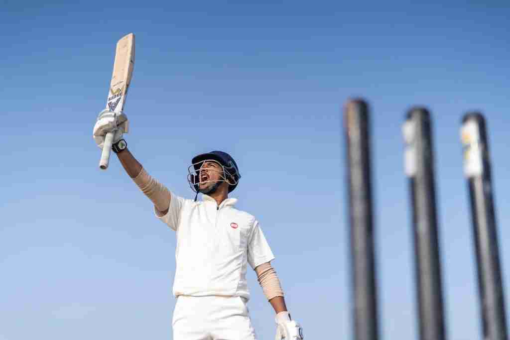 a man holding a bat and wearing a helmet