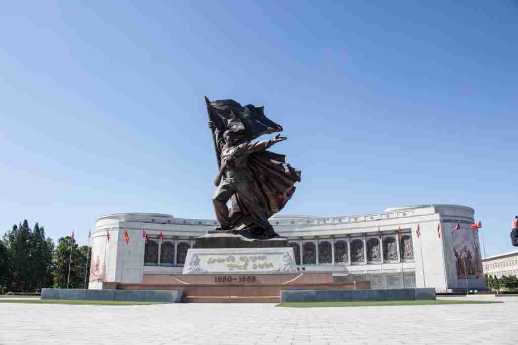 black statue on green grass field during daytime