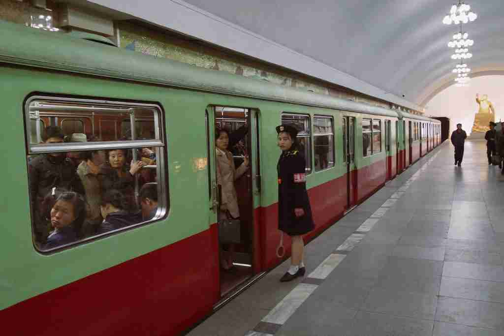 People in North Korea engage in red and white train activities during the daytime, showcasing unique and fun facts about North Korea.