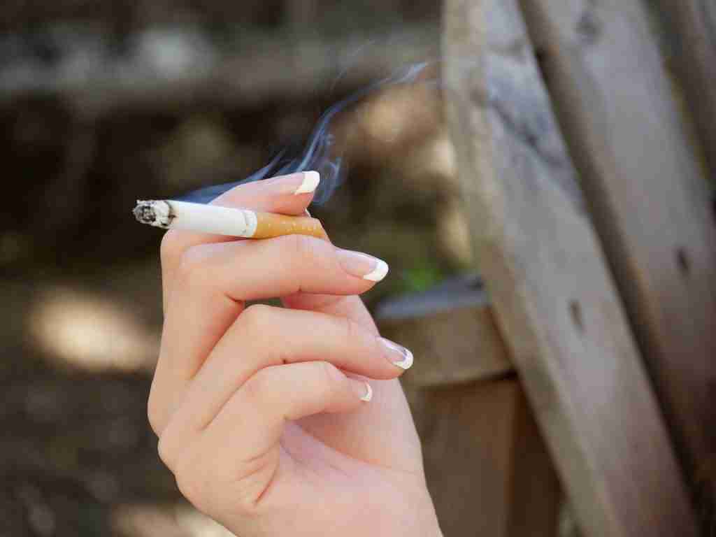 person holding white and blue toothbrush: one of fun facts about the number 3