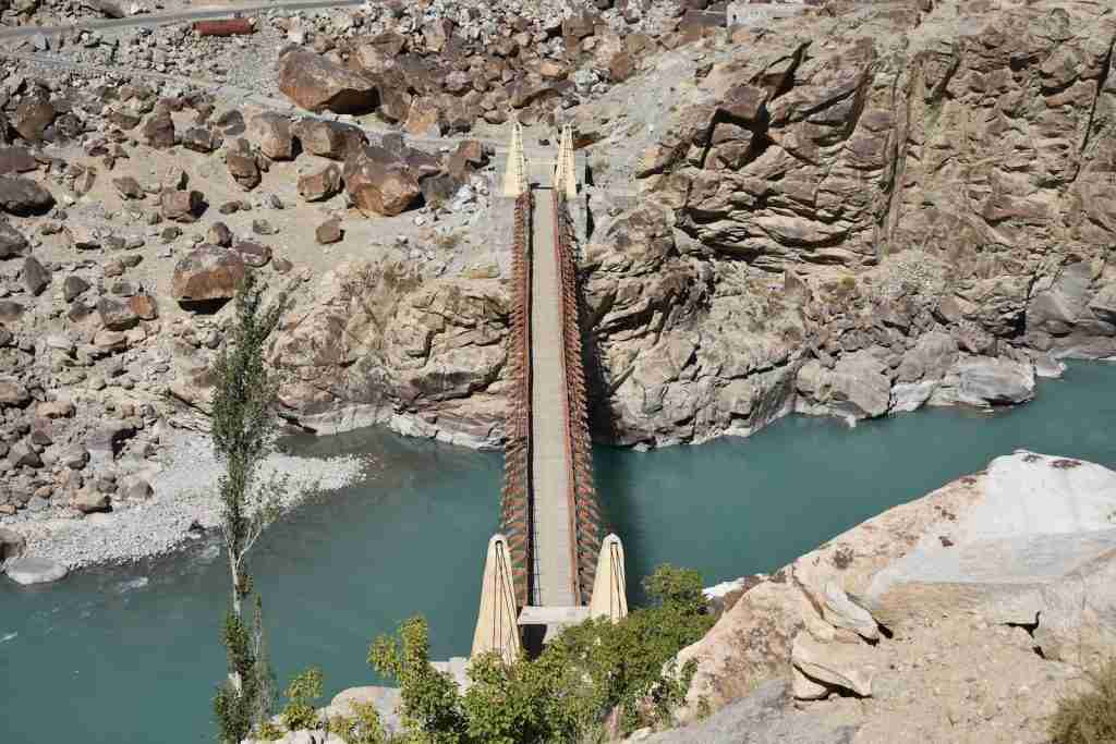 A bridge over the Indus River, surrounded by rocks, showcasing facts about the Indus River's majestic landscape.