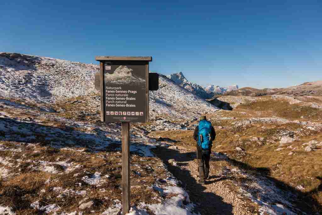 a person standing next to a sign 