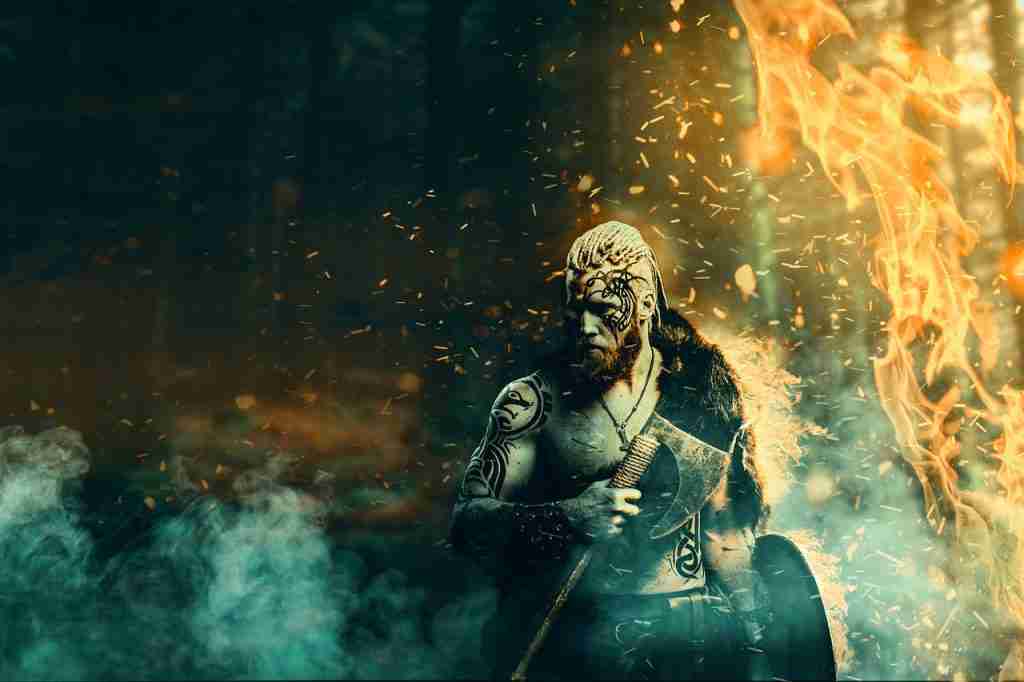 A Viking holding a cleaver in his hand in a dark fire background, showcasing fun facts about Saturday.