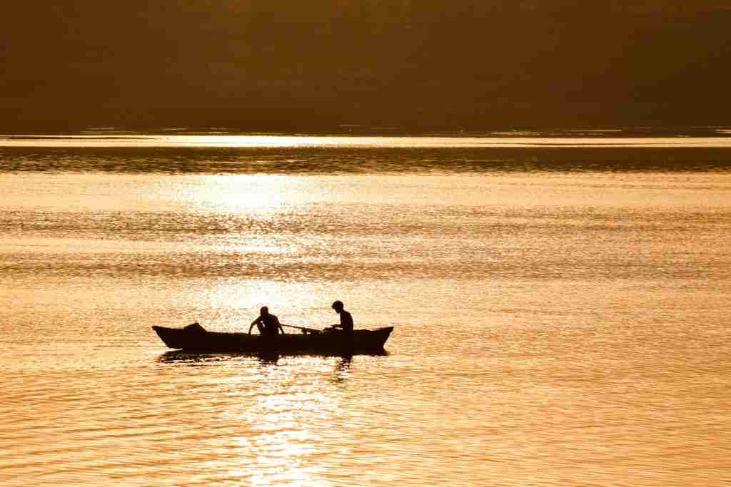 silhouette of two person on boat