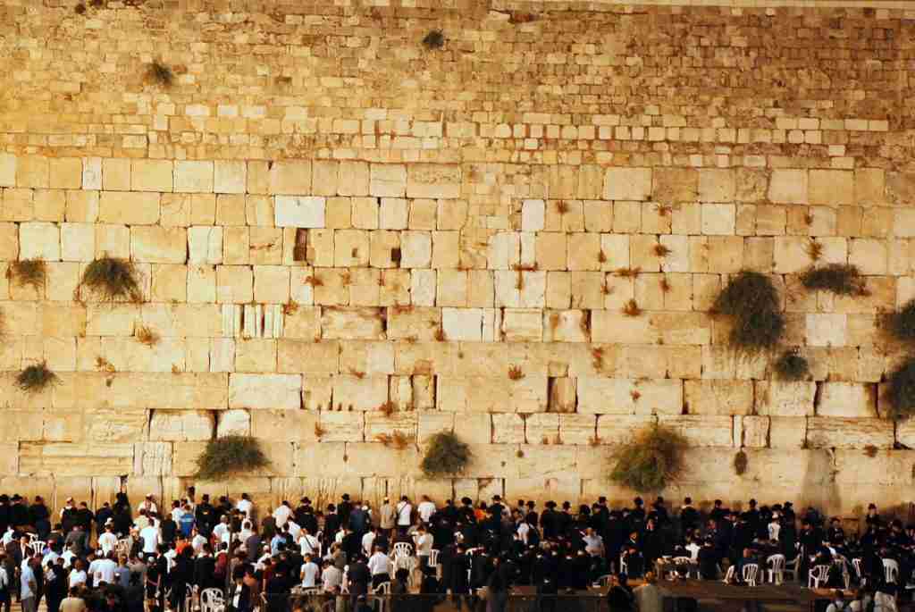 people gathering near brick wall: fun facts about judaism