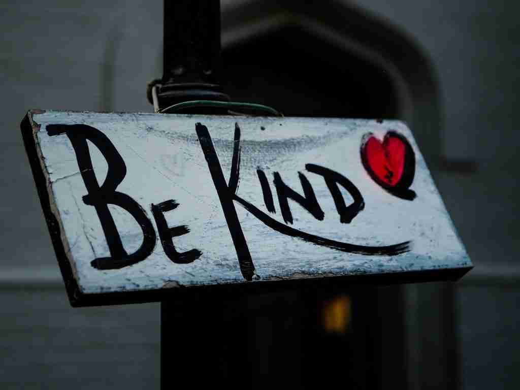 a sign that says be kind on it: fun facts about love