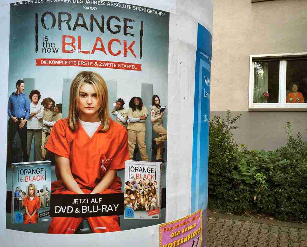 orange is the new black poster on a wall.