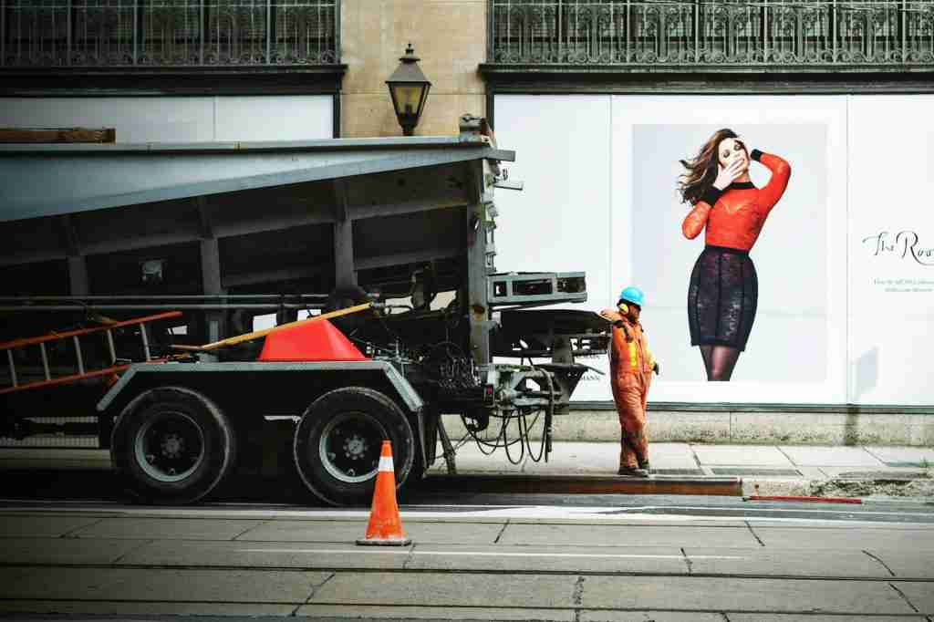 Person wearing orange suit while leaning on truck - Fun Facts About the Color Orange.