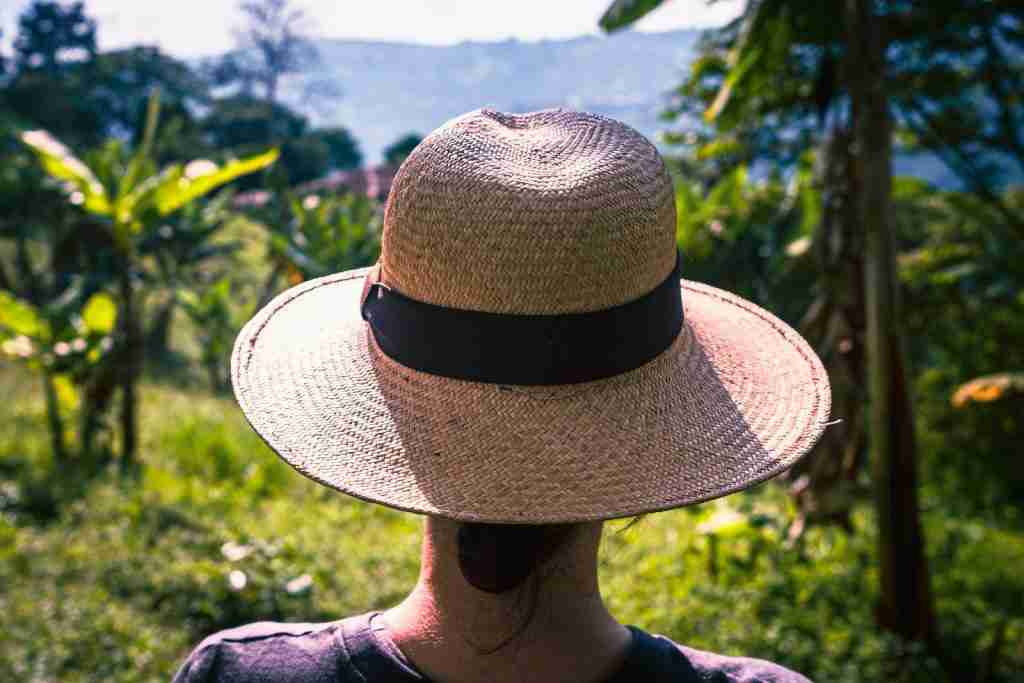 a woman wearing a straw hat in a field: Fun Facts About Ecuador